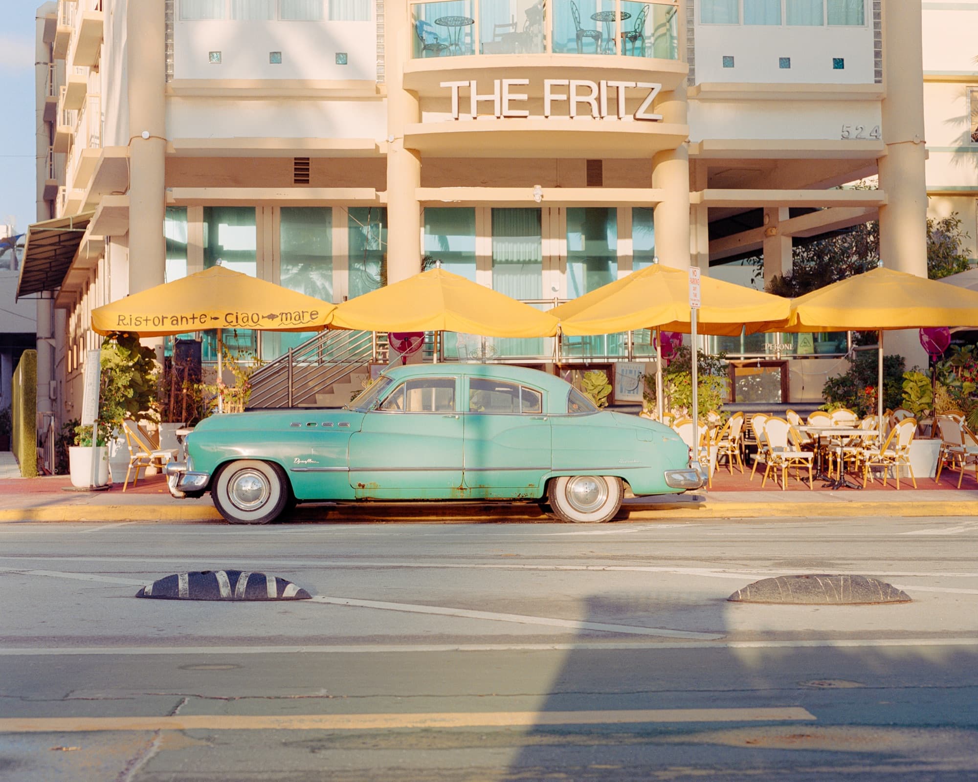 A vintage Buick parked on Ocean Drive — the converted frame beside its RAW capture